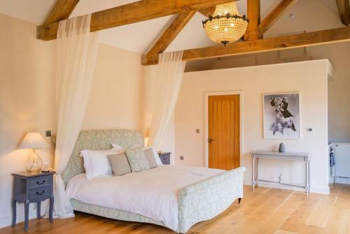 a bedroom with a bed and a wooden floor at Greentrees Estate -The Oak Suite in Haywards Heath