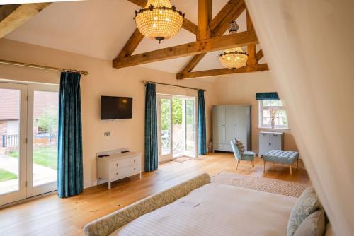 a bedroom with a bed and a tv in a room at Greentrees Estate -The Oak Suite in Haywards Heath