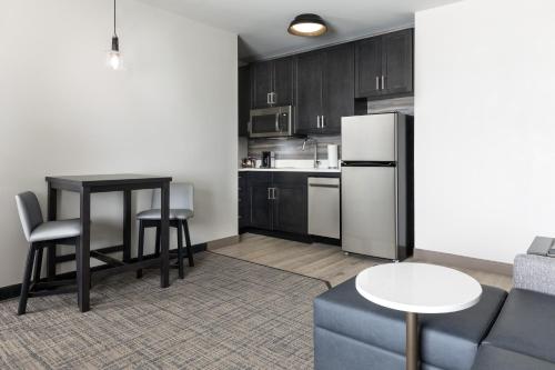 a kitchen with a couch and a table and a refrigerator at Residence Inn Long Island Garden City in Garden City