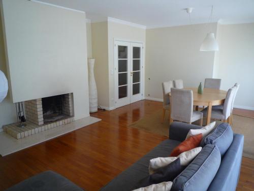 a living room with a couch and a fireplace at Casa da Vinha in Viana do Castelo