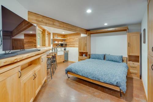 a bedroom with a bed and a kitchen at Enchanting Escape with Hot Tub, Decks and Views! in McKenzie Bridge