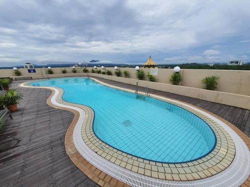 a large swimming pool on top of a building at Lovely Waterfront Riverbank Suite with Pool A2 in Kuching