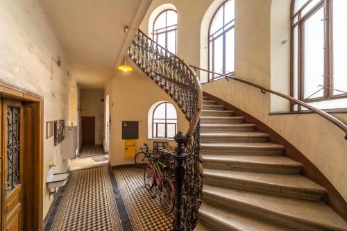a spiral staircase in an old building with a bike at 10 min walk to Schonbrunn l Deluxe Suite in Vienna
