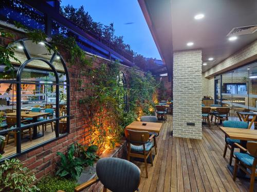 a restaurant with tables and chairs and a brick wall at Ibis Istanbul Airport in Istanbul