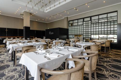 a dining room with white tables and chairs at Olissippo Marques de Sa in Lisbon