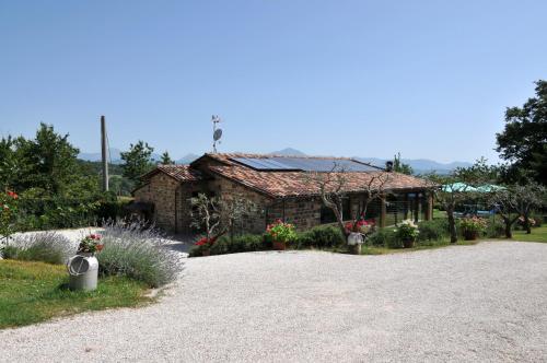 a stone building with a flag on top of it at Casalotto Francescano in Mengara