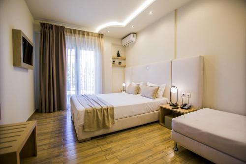 a hotel room with two beds and a window at Kasta Beach Hotel in Ofrínion
