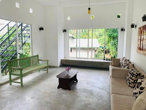 a living room with a couch and a coffee table at Everdew Kandy in Kandy