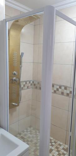a shower with a glass door in a bathroom at 1403 on 10 South Beach in Durban