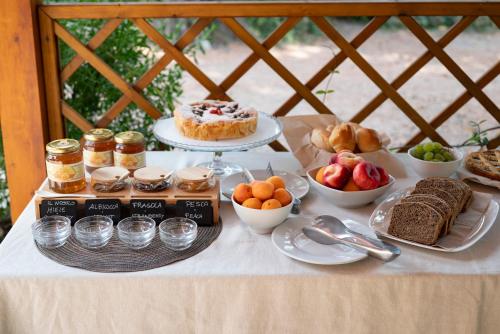 a table with desserts and other food on it at Agriturismo Terre della Rinascita in Castelnuovo della Misericordia