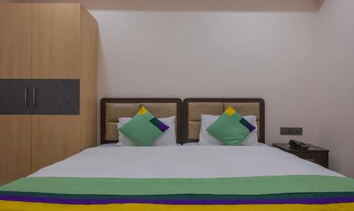 a bedroom with a large white bed with pillows at Treebo Su Casa Grand in Visakhapatnam