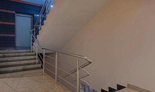a staircase in a building with a metal railing at Treebo Su Casa Grand in Visakhapatnam