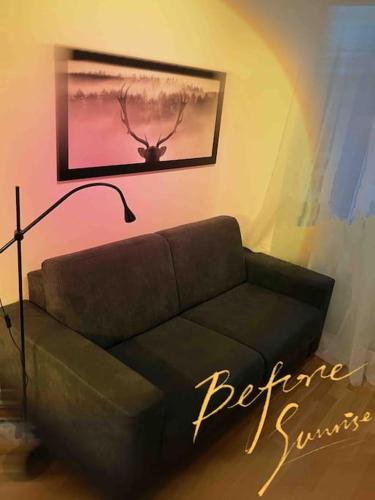 a couch in a living room with a picture of a antelope at Central Apartment in Frankfurt a.M. in Frankfurt