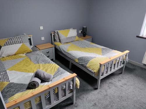 two twin beds in a room with at Harleys Inn in Chesterfield
