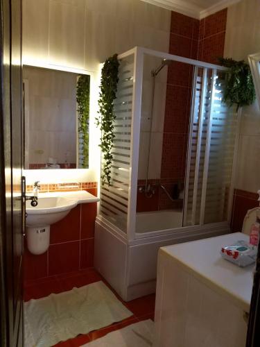 a bathroom with a tub and a sink and a shower at شرم ستار مكتب رقم 230 in Sharm El Sheikh