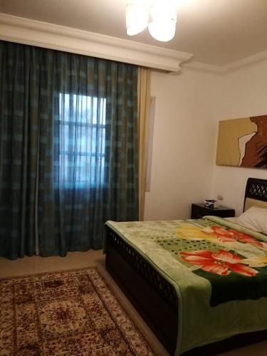 a bedroom with a large bed and a window at شرم ستار مكتب رقم 230 in Sharm El Sheikh