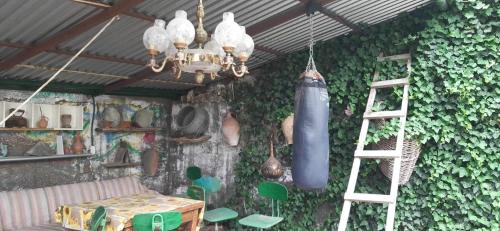 a room with a climbing wall with a ladder and a punching bag at Lovely Goris in Goris