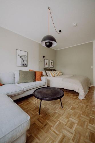 a living room with a white couch and a table at Stylisches Design-Apartment in Bad Tölz