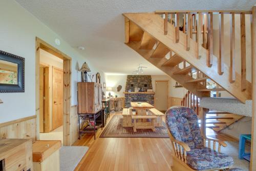 a living room with a staircase and a dining room at Large Home on Lake Edward with Deck and Fire Pit! in Nisswa