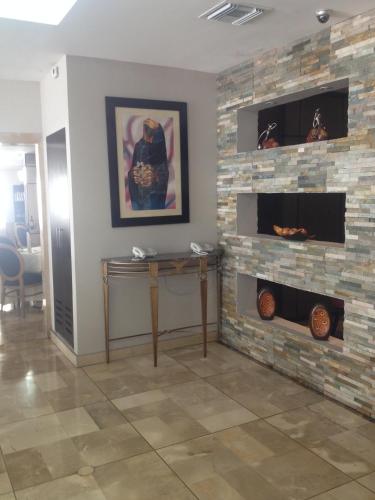a living room with a stone fireplace at Hotel Ramada in Guayaquil
