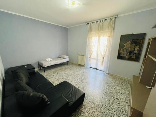 a living room with a couch and a bed at Darsena Fiumicino in Fiumicino