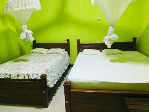 Postel nebo postele na pokoji v ubytování Ambel Homestay