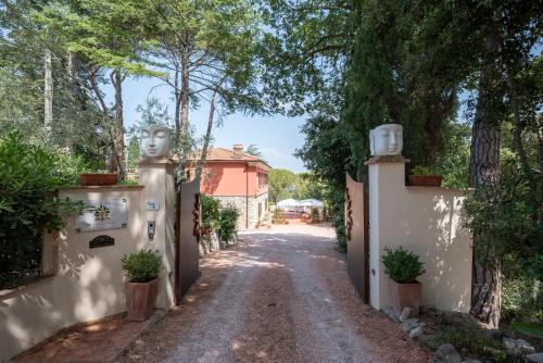 an empty road in front of a house with trees at Agriturismo Terre della Rinascita in Castelnuovo della Misericordia