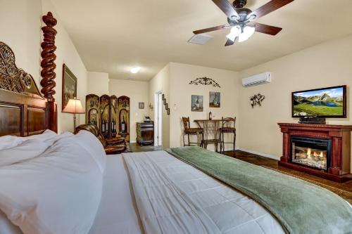 ein Schlafzimmer mit einem großen Bett und einem Kamin in der Unterkunft Romantic Oasis with Hot Tub Near Fred and Wineries! in Fredericksburg