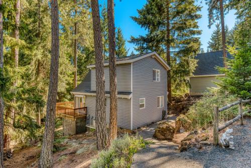 a home in the woods with a deck and trees at Piney Hideaway in White Salmon