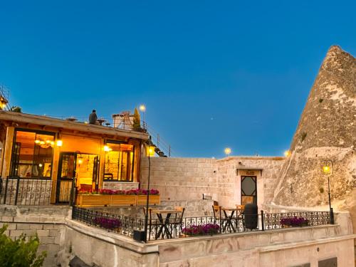 a building with tables and chairs in front of it at Sora Cave Hotel in Göreme