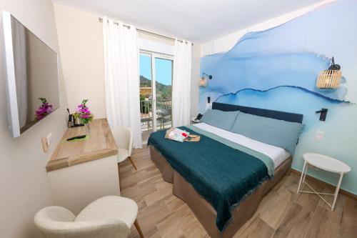 a bedroom with a bed and a table and chairs at Le Saint Erasme, Hotel Eco Friendly in Calvi