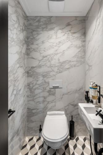 a bathroom with a white toilet and a sink at Numa Prague Republika in Prague