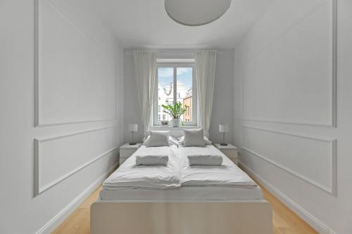 a white room with two beds and a window at WAVE APARTMENTS WHITE PEARL IN GDANSK in Gdańsk