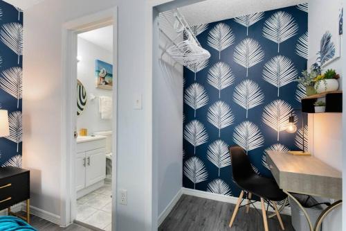 a living room with a blue and white wallpaper at Oasis 105 - Blue Bliss in Titusville