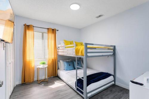 a bedroom with two bunk beds in a room at Oasis 105 - Blue Bliss in Titusville