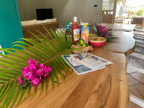 a wooden table with flowers on top of it at Villa - Le Diamant d'Aude - à 200 m de la plage in Le Diamant