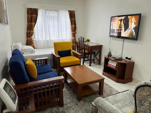 a living room filled with furniture and a flat screen tv at Lux Suites Lantana Road Apartments westlands in Nairobi