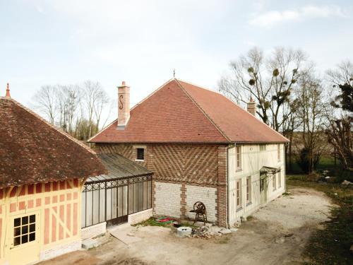 a large house with a red roof and a garage at Studiolo des Sources in Charmont-sous-Barbuise