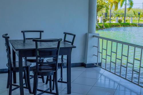 a table and chairs on a balcony with the water at Hotel Sanasuma in Hambantota