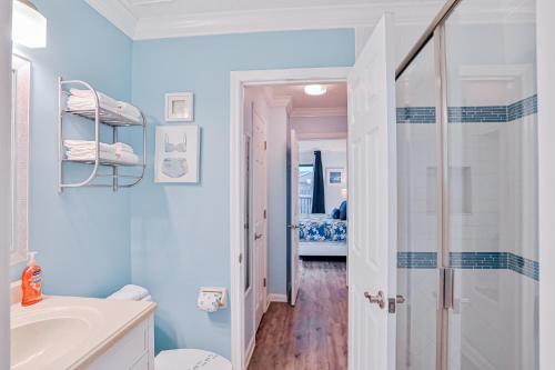 a bathroom with a shower and a toilet and a sink at Modern oceanfront condo with two pools & private washer/dryer in Saint Augustine