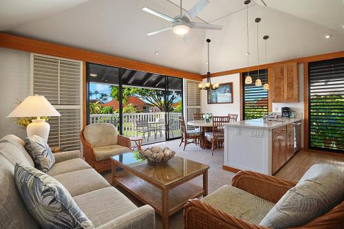 a living room with couches and a table and a kitchen at Kiahuna Plantation Kauai by OUTRIGGER - Select Your Unit in Koloa
