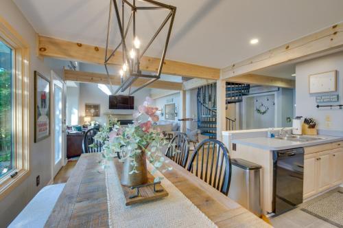 a kitchen and dining room with a long table with flowers at Serene Hideaway with Views, 1 Mi to Hike and Ski! in Wintergreen