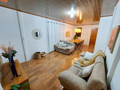 a living room with a couch and a table at Casa Bambú, con ac y wifi in Puerto Jiménez