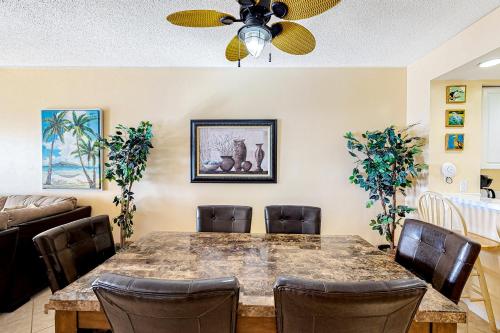 a dining room with a table and chairs at Emerald Isle 1002 in Pensacola Beach