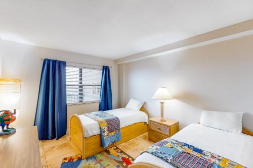 a bedroom with two beds and a window at Emerald Surf 502 in Navarre
