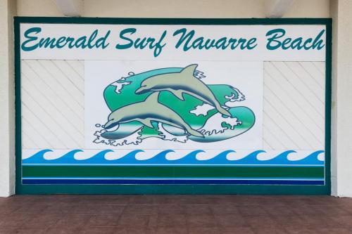 a sign for an aquarium with dolphins in the water at Emerald Surf 502 in Navarre