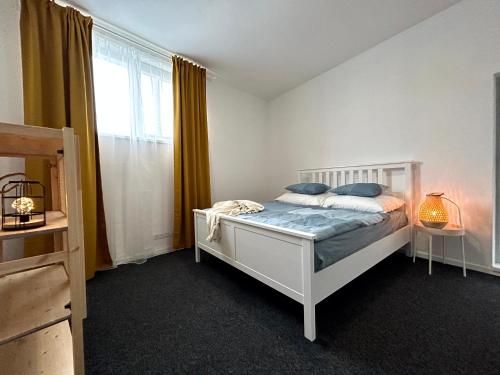 a bedroom with a white bed and a window at BREZA HOUSE apartments in Zlín