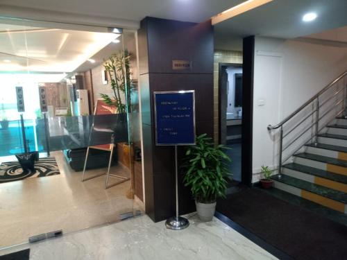 a lobby with a sign in front of a building at The Contour Hotel in Guwahati
