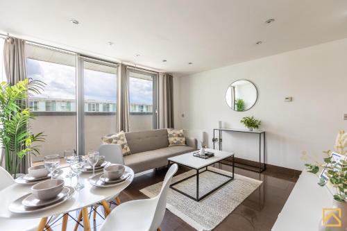a living room with a couch and a table at Luxury 2-bed In central MK By Valore Property Services in Milton Keynes