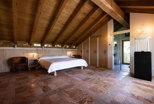 a bedroom with a bed and a wooden ceiling at La Cucchetta in Dormelletto